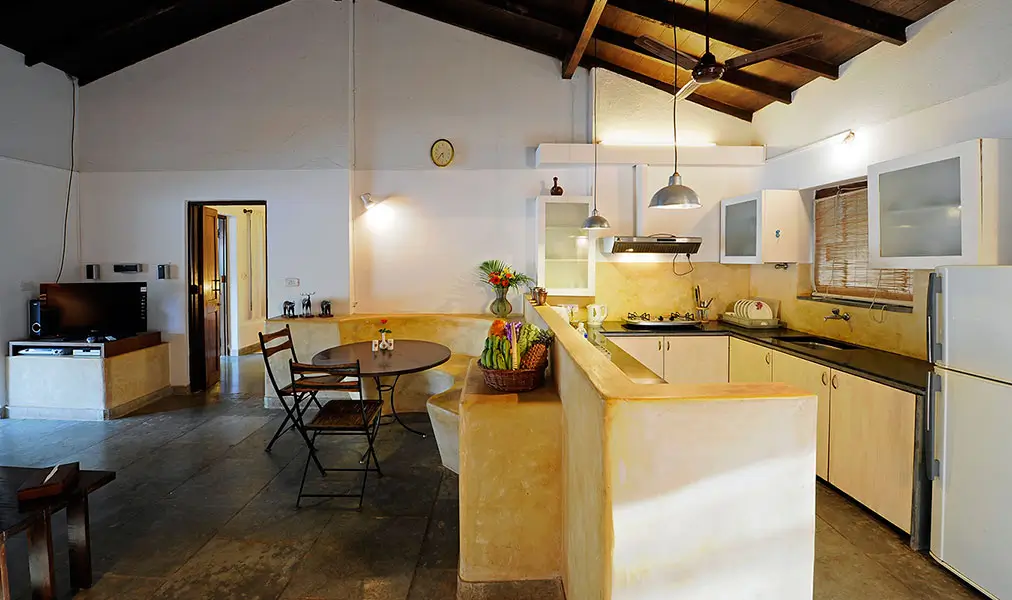 Bright open kitchen and dining space at Aashyana Lakhanpal with island counter seating and fully equipped