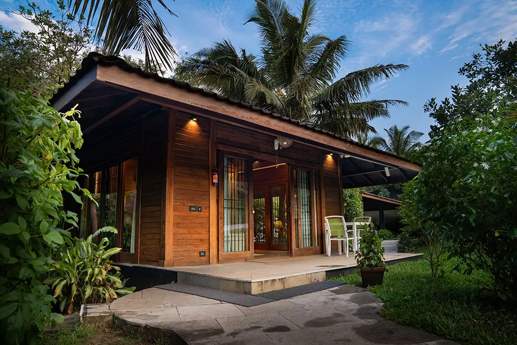 Taurus 1 & 2 one-bedroom cottages at Aashyana Lakhanpal, featuring cozy double-bed interiors, a private sit-out, and lush garden surroundings for a relaxed beachside stay.